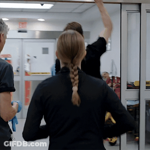 Woman In Braided Ponytail Standing In Front Of Sliding Glass Door Saying Mat GIF