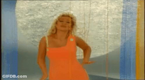 Woman In Bright Orange Dress Dancing Blue Wall GIF