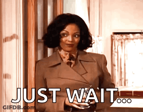 Woman In Brown Coat Holding Wine Saying Just Wait GIF