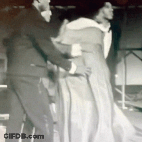 Woman In Brown Dress And Brooch Smiling GIF