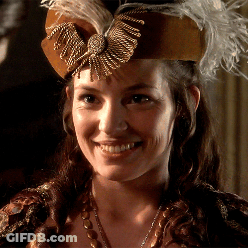 Woman In Brown Hat With Feathers GIF