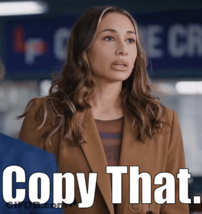Woman In Brown Jacket With Sign Copy That GIF