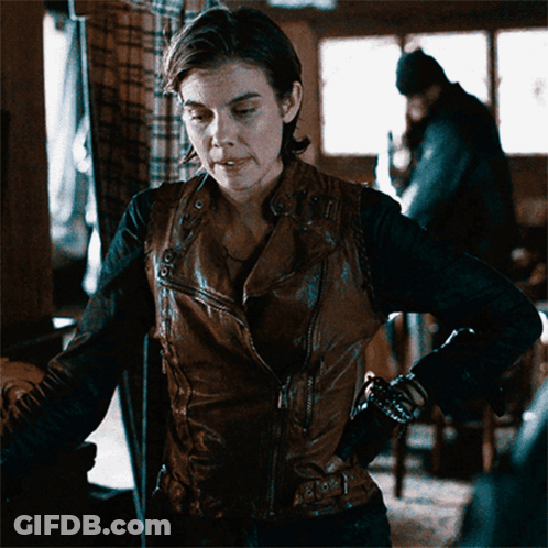 Woman In Brown Leather Jacket In Dark Room GIF