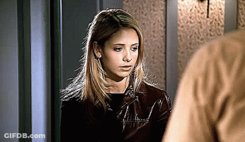 Woman In Brown Leather Jacket Next To Man In Brown Shirt GIF