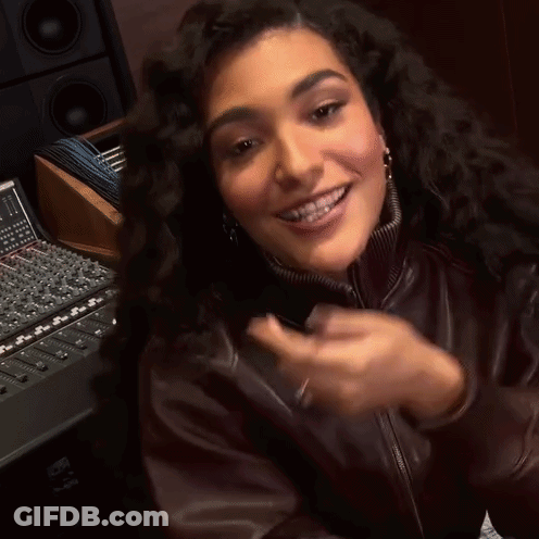 Woman In Brown Leather Jacket Smiling And Clapping GIF