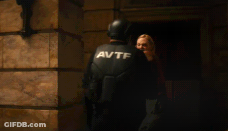 Woman In Brown Shirt Holding Knife GIF