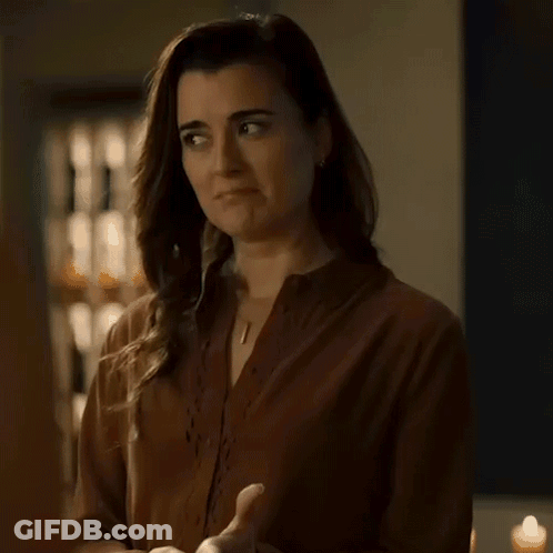 Woman In Brown Shirt Making No Deal Gesture GIF