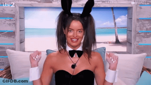 Woman In Bunny Ears And Bow Tie On Couch GIF