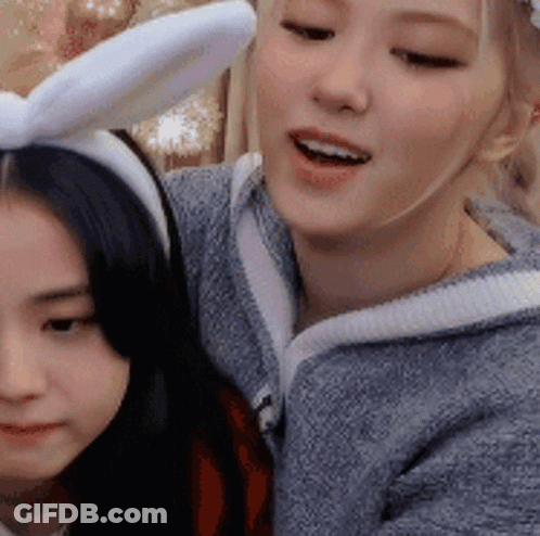 Woman In Bunny Ears Beside Another Woman GIF