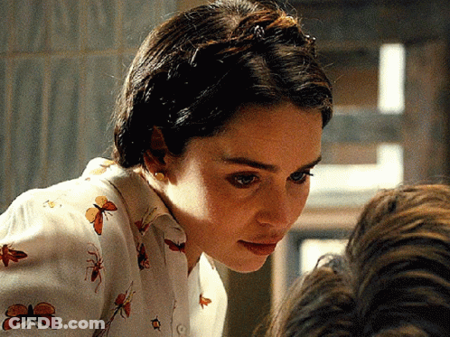 Woman In Butterfly Shirt Looking Down GIF