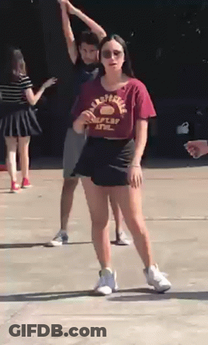 Woman In California State Shirt On Sidewalk With Others GIF