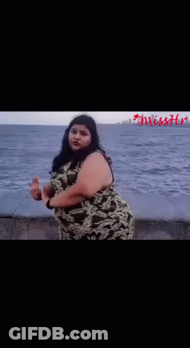 Woman In Camouflage Dress On Beach Near Ocean GIF