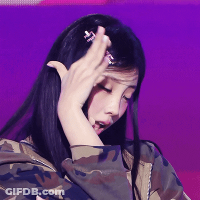Woman In Camouflage Jacket Hand To Head GIF