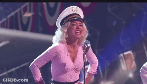 Woman In Captain Hat Singing Into Microphone GIF