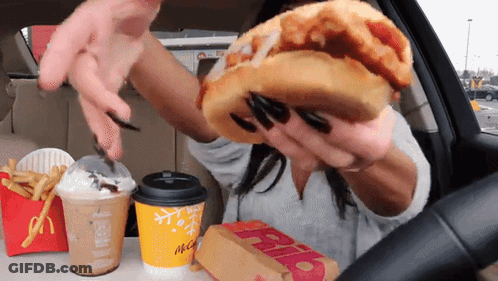 Woman In Car Eating McDonald's Hamburger GIF
