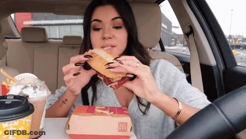 Woman In Car Eating McDonald's Sandwich GIF