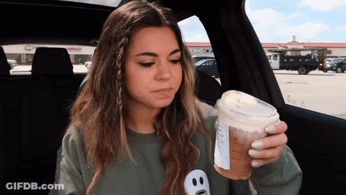 Woman In Car Holding Coffee Cup With Big O Logo GIF