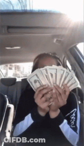 Woman In Car Holding Money GIF