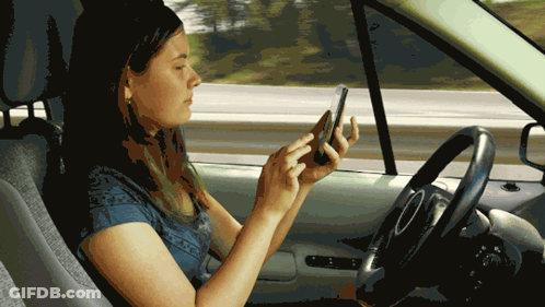 Woman In Car Looking At Cell Phone GIF