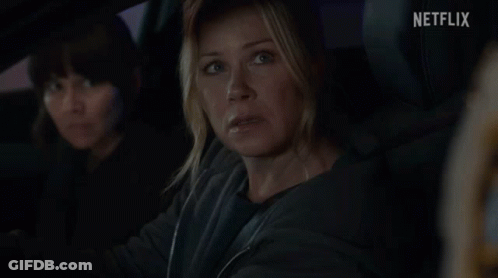 Woman In Car With Netflix Logo GIF