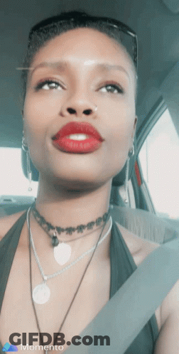 Woman In Car With Red Lipstick, Choker, And Memento Logo GIF