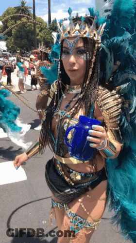 Woman In Carnival Costume Holding Blue Cup GIF
