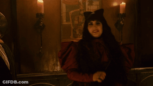 Woman In Cat Costume Holding Knife In Dark Room GIF