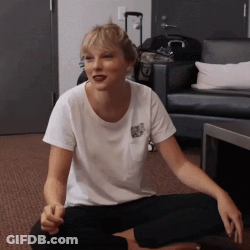 Woman In Cat T-Shirt Sitting On Floor GIF