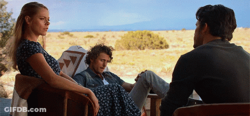 Woman In Chair Next To Two Men GIF