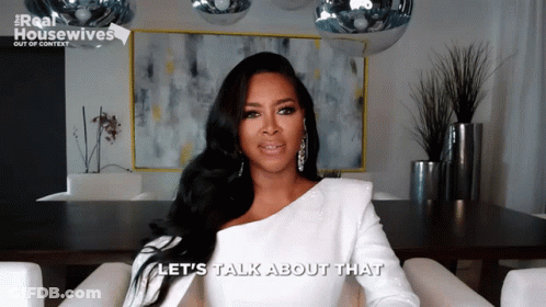 Woman In Chair Saying Let's Talk About That GIF
