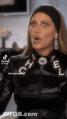 Woman In Chanel Jacket And Earrings GIF