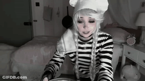 Woman In Chef Costume Sitting With Bowl Of Food GIF