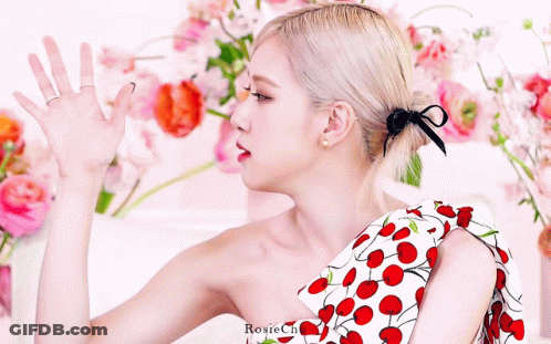 Woman In Cherry Dress Standing In Flowers GIF