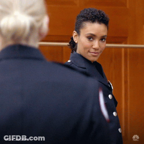 Woman In Chicago Fire Uniform Smiling At Another GIF