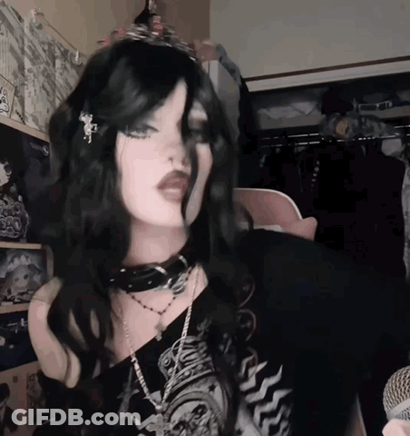 Woman In Choker And Tiara At Microphone GIF