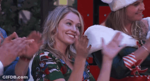 Woman In Christmas Sweater Smiling And Applauding GIF