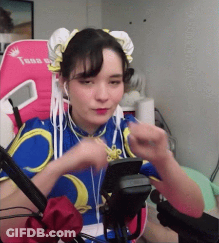 Woman In Chun Li Costume Sitting GIF