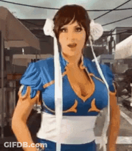 Woman In Chun Li Costume Standing In Front Of Umbrella GIF
