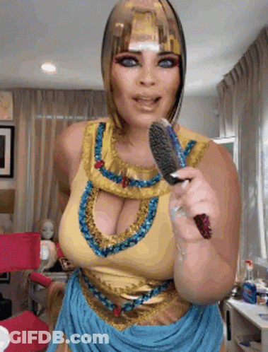Woman In Cleopatra Costume Brushing Hair GIF