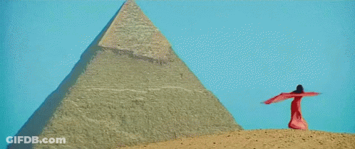 Woman In Cleopatra Costume Brushing Hair GIF