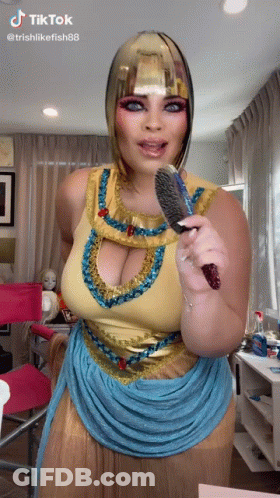 Woman In Cleopatra Costume Holding Brush GIF