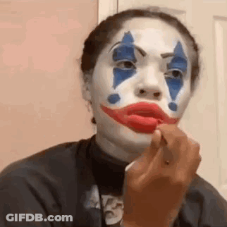 Woman In Clown Costume Applying Lipstick GIF
