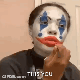 Woman In Clown Makeup Applying Red Lipstick GIF
