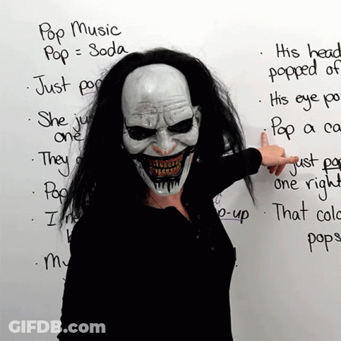 Woman In Clown Mask Pointing To Pop Music List GIF