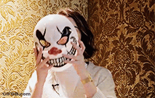 Woman In Clown Mask Standing In Front Of Wall GIF