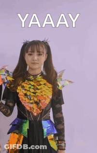 Woman In Colorful Costume Raising Fist Saying Yaaay GIF