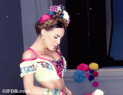 Woman In Colorful Crop Top And Earrings GIF