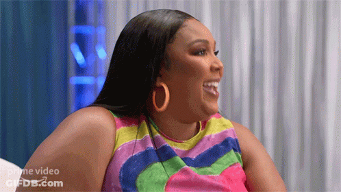 Woman In Colorful Dress And Hoop Earrings GIF