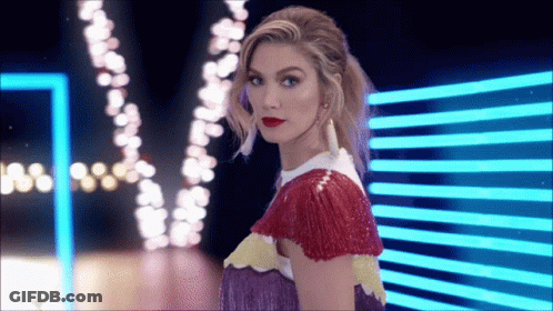 Woman In Colorful Dress In Front Of Blue Light GIF