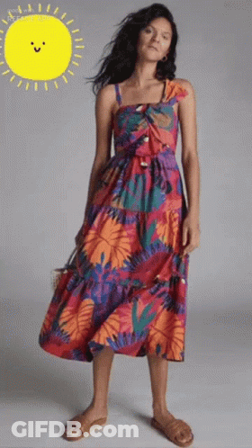 Woman In Colorful Dress In Front Of Yellow Sun GIF